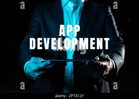 Text caption presenting App Development, Business overview gathering of showing for the purpose of discussing an issue Businessman Holding Tablet With Stock Photo