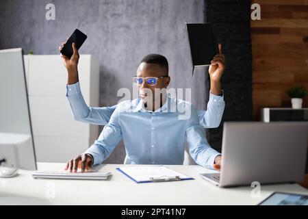 Multitasking Workload Of Happy Busy Man Worker In Office Stock Photo
