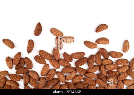 Scattered almonds on a white background. Scattering of almonds. Healthy snack with nuts. Stock Photo