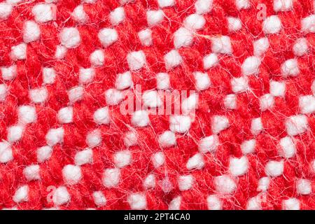 Handmade knitted fabric. red and white woolen background Stock Photo