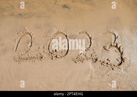 2023 is written in the sand on the banks of the Dnieper River in Ukraine, year Stock Photo