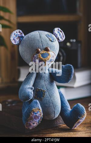 Blue Handmade Bear Toy Sitting on Wooden Surface Stock Photo