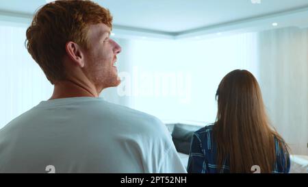 Caucasian young married couple entering the apartment and hugging feeling happy. Close up. Joyful man and woman in new home. Couple has bought new Stock Photo