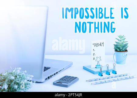Conceptual caption Impossible Is Nothing, Word Written on Motivated to achieve something despite challenges Stock Photo