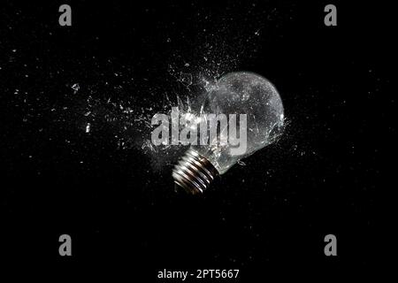 light bulb shattering on black Stock Photo