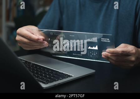 Businessman using laptop computer icon virtual screen education online and e learning on desk. Stock Photo