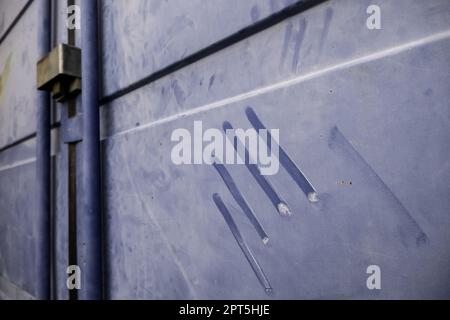 Dirty metallic wall detail with traces of a hand Stock Photo