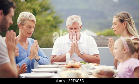 Big family food, praying thanks and prayer for lunch, dinner table and worship, gratitude and respect in Australia. Kids, parents and grandparents tru Stock Photo