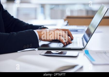 First things first, let me respond to my emails. Closeup shot of an unrecognisable businessman working on a laptop in an office Stock Photo