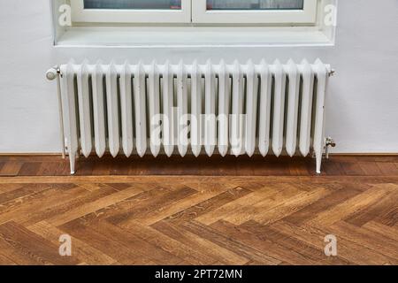 Heating radiator in an indoor space Stock Photo