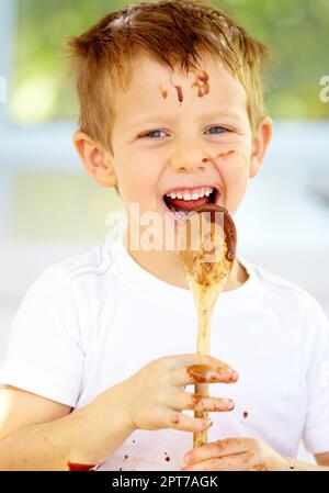 The future of the culinary arts. A little boy covered in dough and flour Stock Photo
