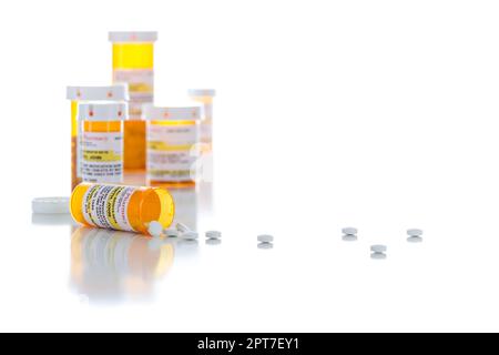 Non-Proprietary Medicine Prescription Bottles and Spilled Pills Isolated on a White Background. Stock Photo
