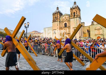 Good Friday Silent procession in Oaxaca Mexico during the Semana Santa  (Easter)/ Participants with crosses wear hoods to create anonymity and symbolize equality before God Stock Photo