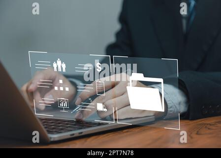 ERP Enterprise resource planning document management concept.Businessman using with laptop computer with icons on desk. Stock Photo