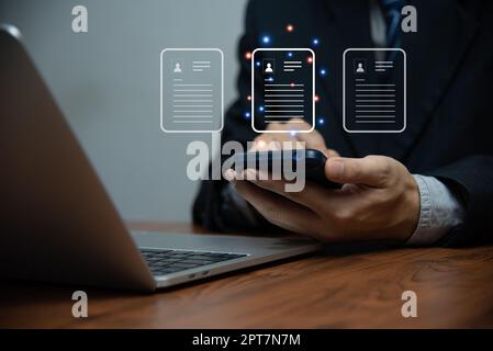 Businessman touching on virtual screen. Enterprise Resource Planning ERP document management concept with icons on the virtual screen. Stock Photo