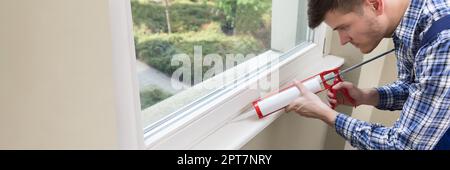 Caulking Silicone Sealant To Repair Window In House Stock Photo