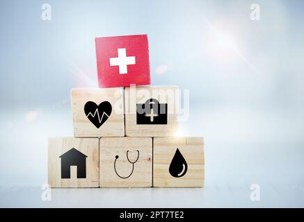 For those moments in life you didnt expect. wooden blocks with insurance related symbols on them Stock Photo