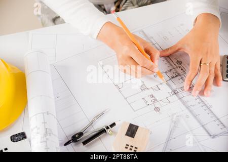 Architectural project workspace. Top view of architect drawing with ruler on house plan blueprint paper for repair tools on table desk at architecture Stock Photo