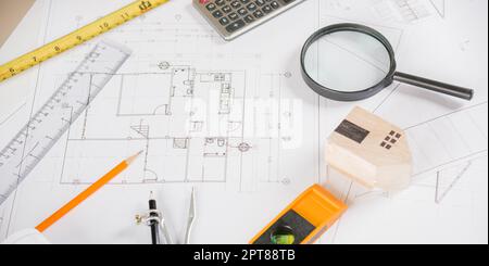 Architectural project workplace. Top view of house plan blueprint paper with repair tools on table desk at architecture office, Engineering architect Stock Photo