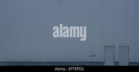 Texture of a high metal wall of an industrial building without windows Stock Photo