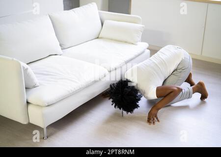 African Woman Lost Key Or Phone. Searching For Something Stock Photo