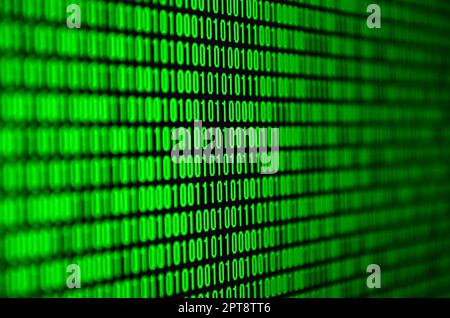 An image of a binary code made up of a set of green digits on a black background Stock Photo
