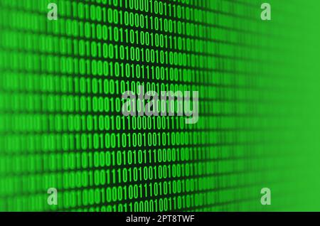 An image of a binary code made up of a set of green digits on a black background Stock Photo