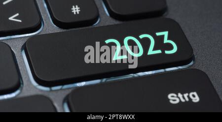 A keyboard with a blue button - 2023 A keyboard with a illuminated button - 2023 Stock Photo