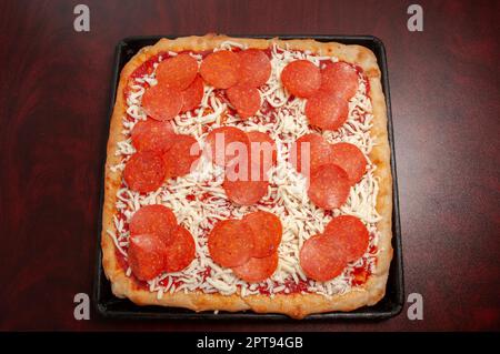 Delicious hot and tasty deep dish pepperoni pizza Stock Photo