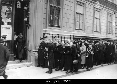 Queues of people outside a polling station in Vienna on April 10 1938. The referendum was on the subject of should Austria become a part of Germany? The vote was after the Anschluss and 99.73% voted yes. The vote was of course tilted in the Nazi's favour by the fact that opposition parties were not alowed to vote and people had to mark their ballot paper in frnt of an election official. Image Bundesarchiv, Bild 183-2006-1411-500 / CC-BY-SA 3.0 Stock Photo