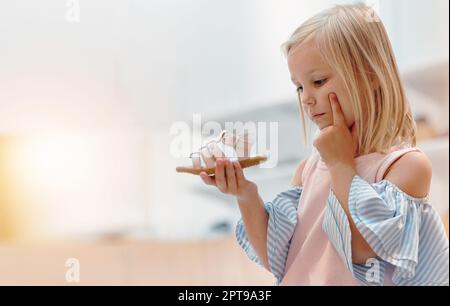 Children, shoes and fashion with a girl thinking about a choice in a retail store or mall while shopping. Kids, idea and customer with a female child Stock Photo