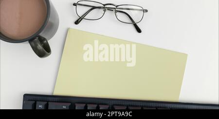 Office Supplies Over Desk With Keyboard And Glasses And Coffee Cup For Working Stock Photo