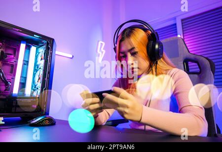 Portrait of angry gamer guy wearing headset yelling while playing video ...