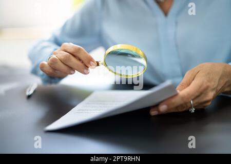 Fraud Detective Using Magnifying Glass Or Loupe Stock Photo