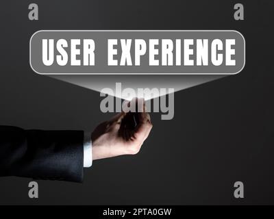 Sign displaying User Experience, Business approach how a person reacts and feels after using a specific product Businessman in suit holding tablet sym Stock Photo