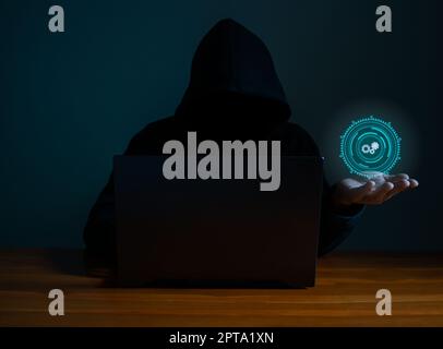 Hackers work on laptops in the dark. The concept of information security in the Internet network and information espionage. Stock Photo