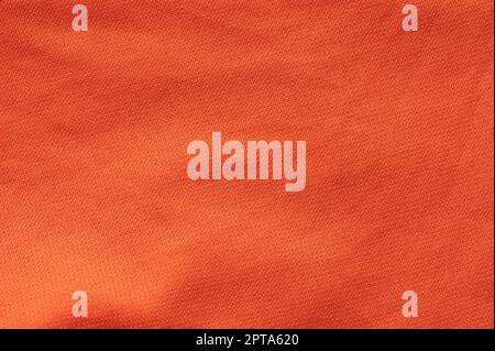 Pattern of fabric material orange color macro close up view Stock Photo