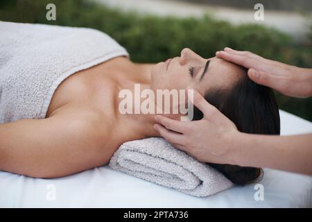 Realigning body and mind. an attractive woman enjoying a massage at a ...
