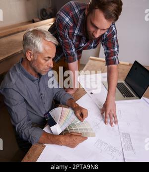 Turning his vision into reality. An architect drawing up plans Stock Photo