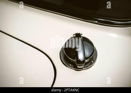 Fuel tank cap with key slot on white vintage car or bus. Stock Photo