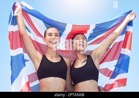 Sports women, athletes and british flag team winning celebration, event and international contest outdoor. Happy, excited and english united kingdom c Stock Photo