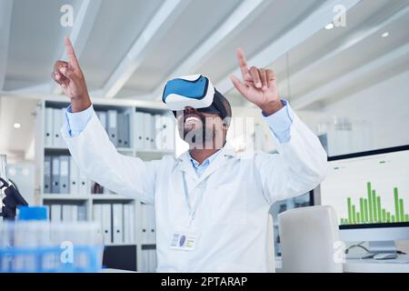 Science changes the way you see the world. a mature scientist using a virtual reality headset while working in a lab Stock Photo