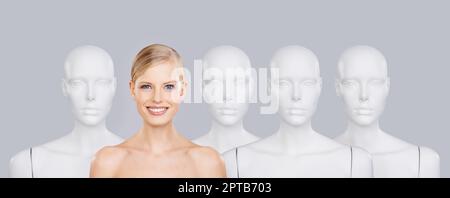 Dont be another face in the crowd. A beautiful young woman standing amongst a row of mannequins Stock Photo