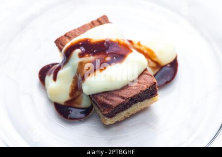 marble sponge cake with creamy custard sauce Stock Photo