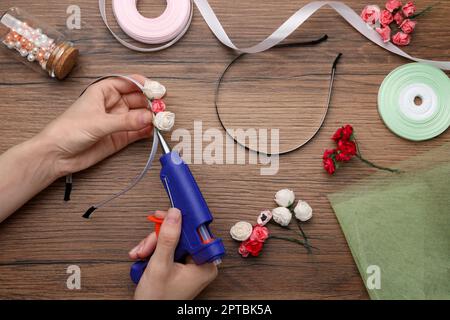 Woman make floral decor with melt glue gun Stock Photo - Alamy