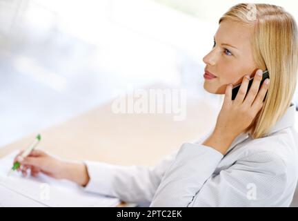 Keeping on top of a busy schedule. Cropped view of a smiling receptionist working Stock Photo