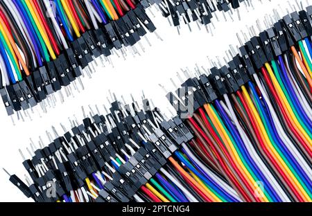 Ribbon cable or multi-wire planar cable on white background. Flat ribbon cable with pin connectors. Multi-colored ribbon computer connecting cable. Co Stock Photo