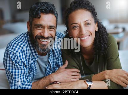 Were still crazy about each other. Portrait of a happy laid-back couple relaxing together at home Stock Photo