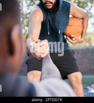 Hands, basketball and help with a man athlete and rival playing a competitive game on a sports court. Team, exercise and assistance with a basketball Stock Photo