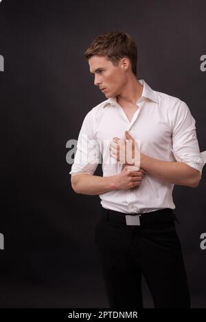 Dressed for a night out. A handsome young man standing against a black background Stock Photo